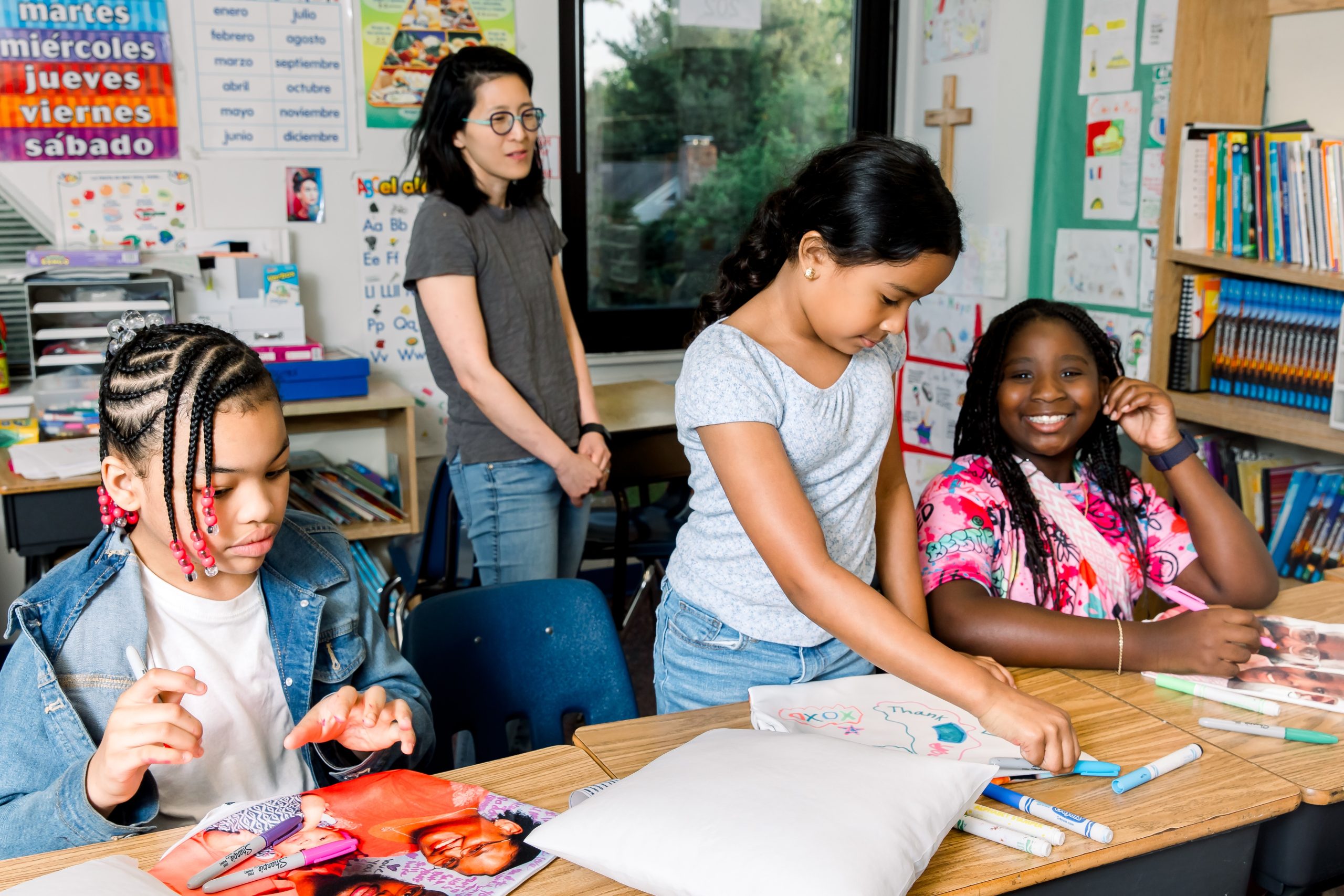 Three grade school aged girls participate in an activity at The Bereavement Center of Westchester's Treehouse grief support program.