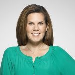 Image of white woman with brown hair wearing a green blouse.