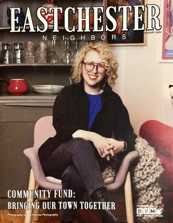 A photo of a magazine cover featuring a White woman with blonde hair who is seated in a pink chair in a home setting.