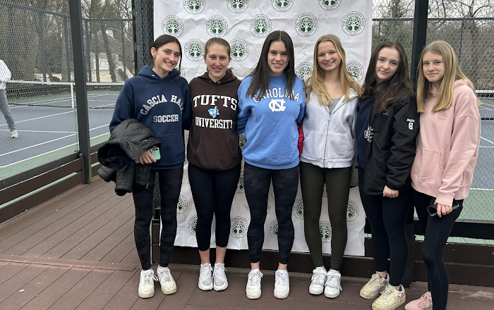 Six White teenagers pose for a group photo at paddleball courts during a tournament fundraiser.