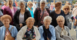 A group photo of several older White women on a recreation trip.