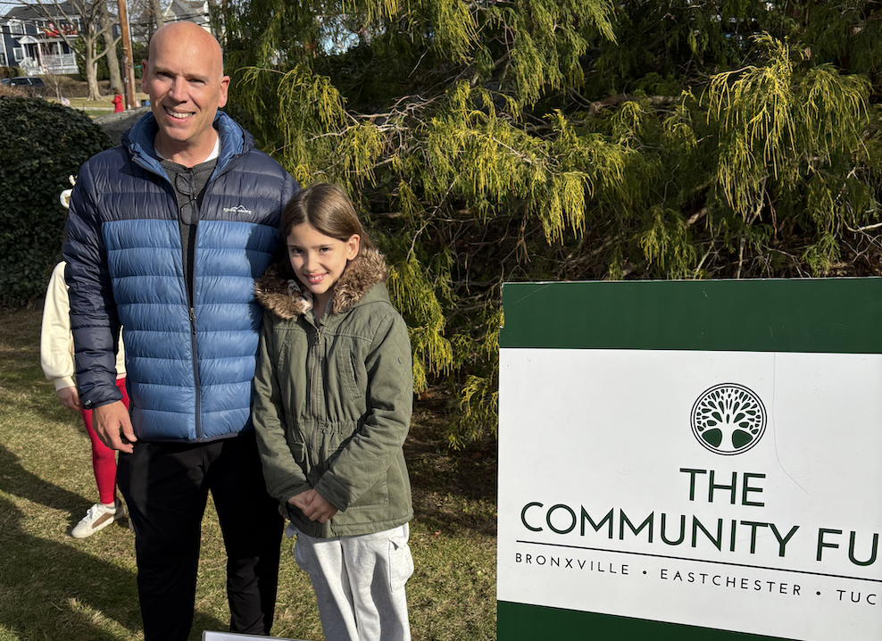 A White male father and his elementary school aged daughter participate in Eastchester Winterfest.